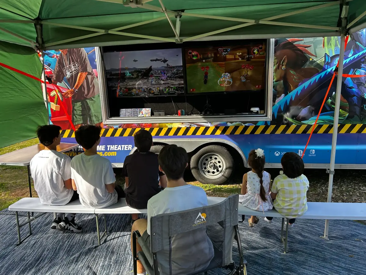 Outdoor gaming setup under a canopy at an event