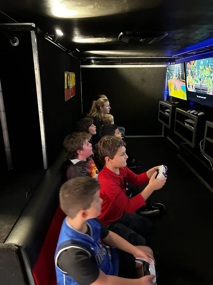 Group gathered around the screens mid-game